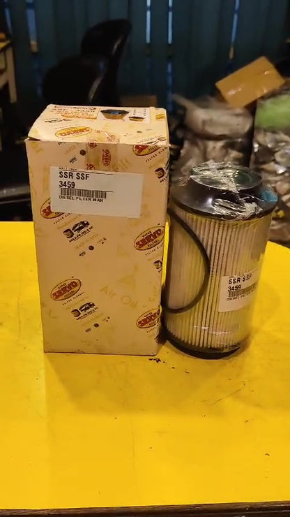 Box and oil filter on a yellow surface with a blurred background